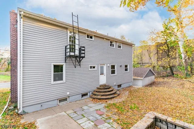 a view of a backyard with table and chairs and wooden fence