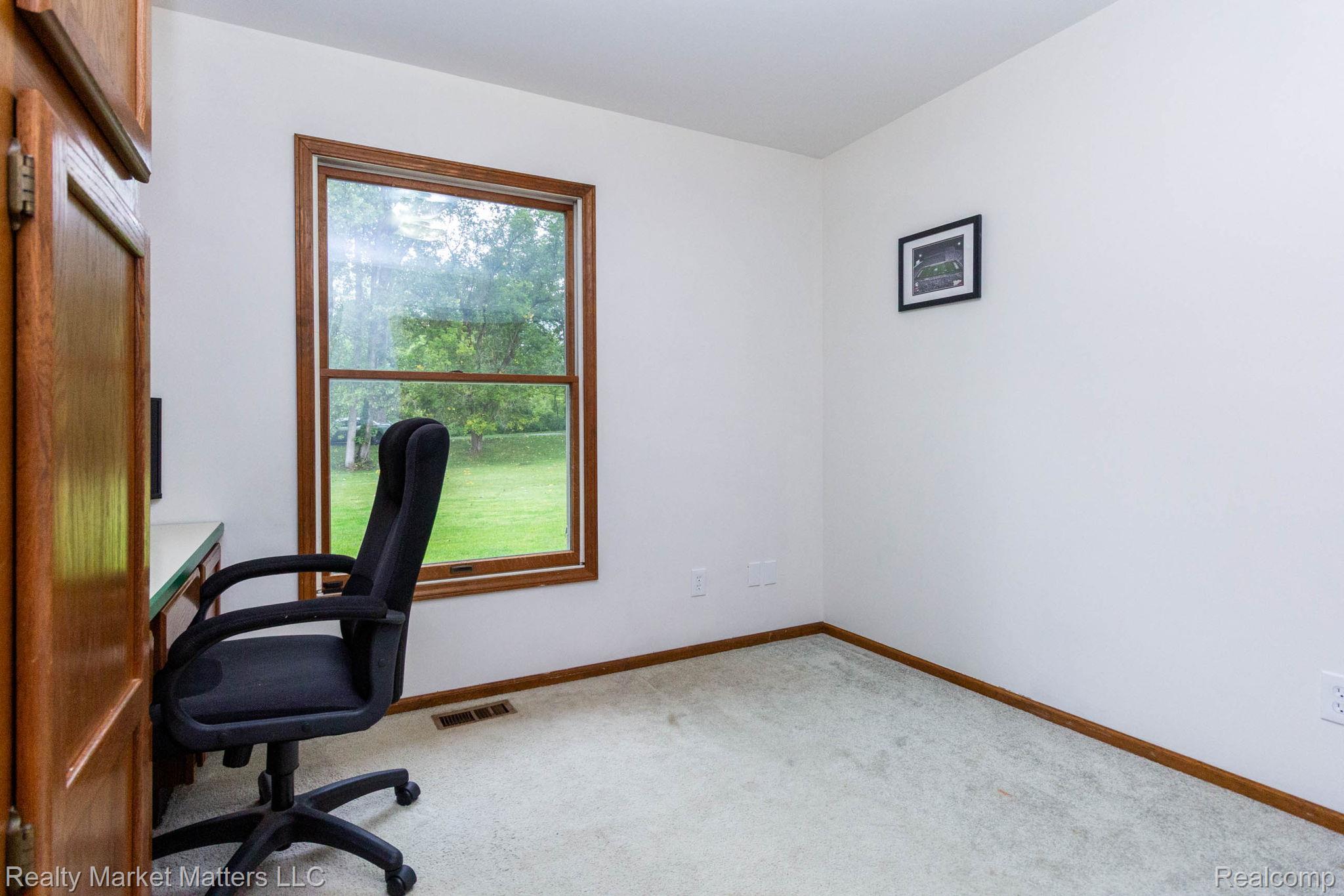 770 North Fairgrounds Road Imlay City, MI 48444 - Photo 22 of 55 Built-in wood-finish cabinetry, window with wood-finish trim, light-toned carpeting, and white wall finishes