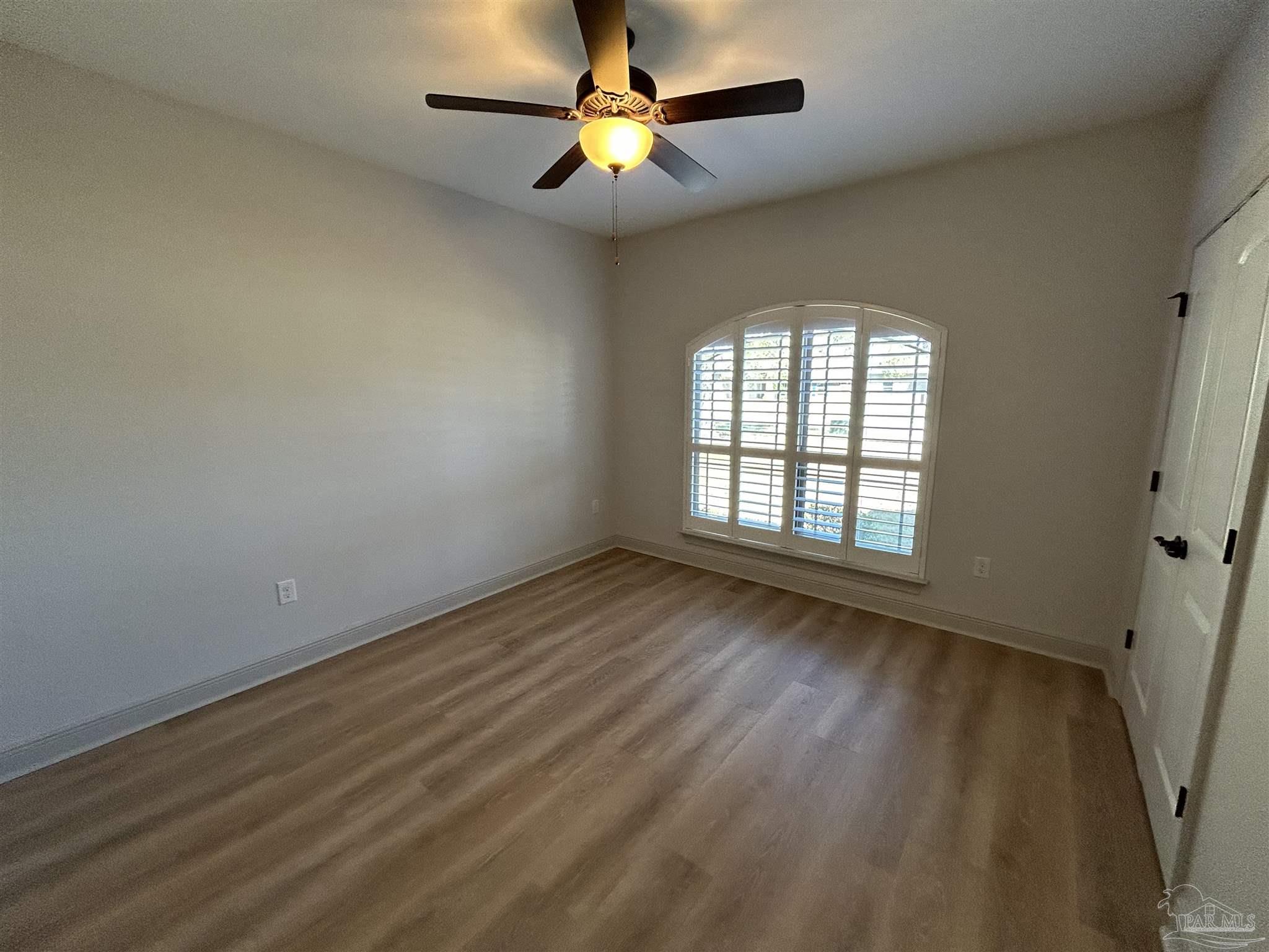 4081 Manchester Court Pace, FL 32571 - Photo 11 of 34 wooden floor in an empty room with a window