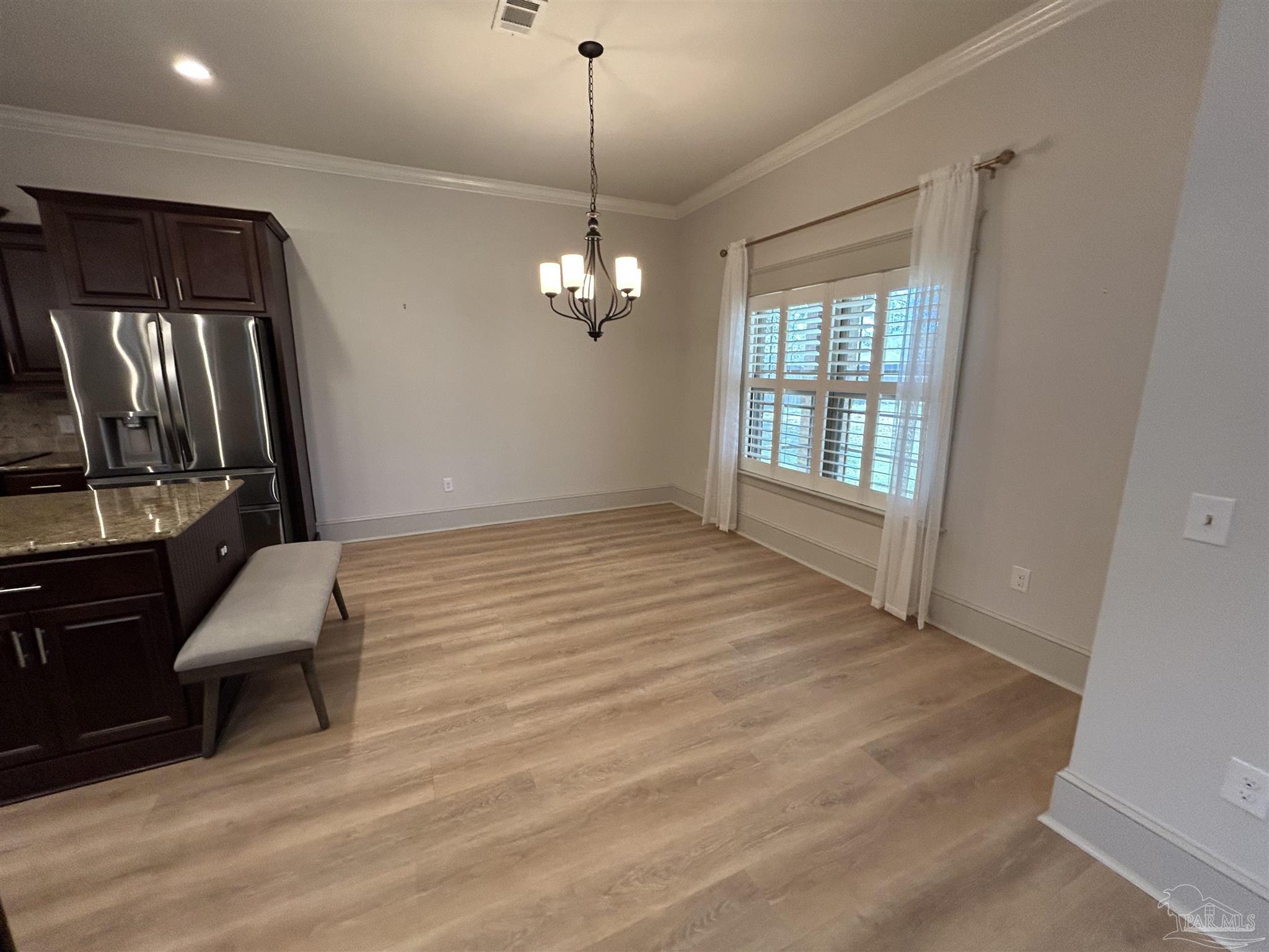 4081 Manchester Court Pace, FL 32571 - Photo 14 of 34 a view of an empty room with wooden floor and a window