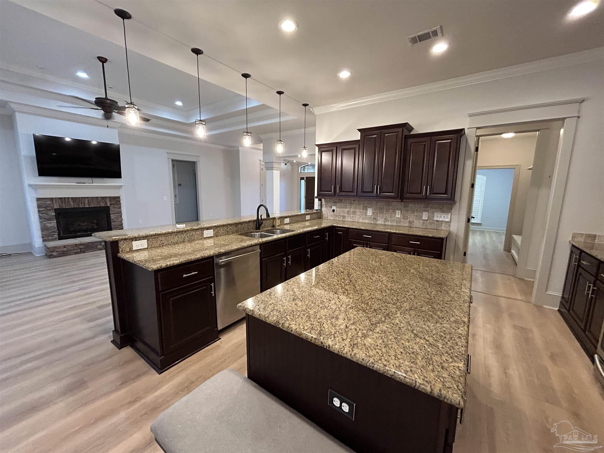 4081 Manchester Court Pace, FL 32571 - Photo 16 of 34 a kitchen with stainless steel appliances granite countertop a sink a stove and a refrigerator