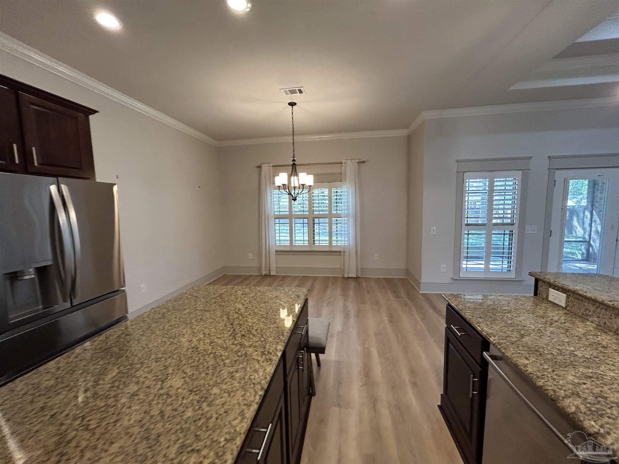 4081 Manchester Court Pace, FL 32571 - Photo 18 of 34 a view of a kitchen cabinets and wooden floor