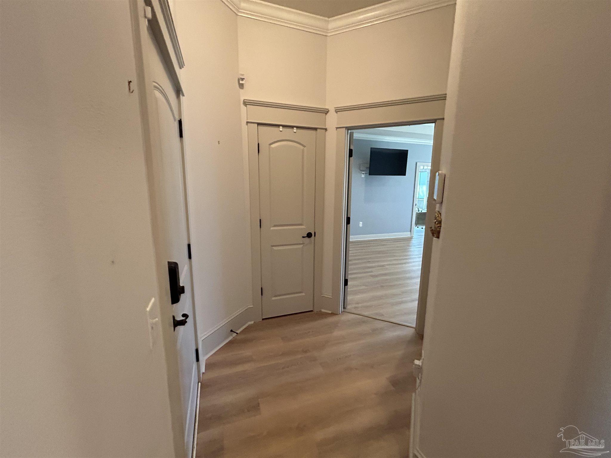 4081 Manchester Court Pace, FL 32571 - Photo 21 of 34 a view of a hallway with wooden cabinets