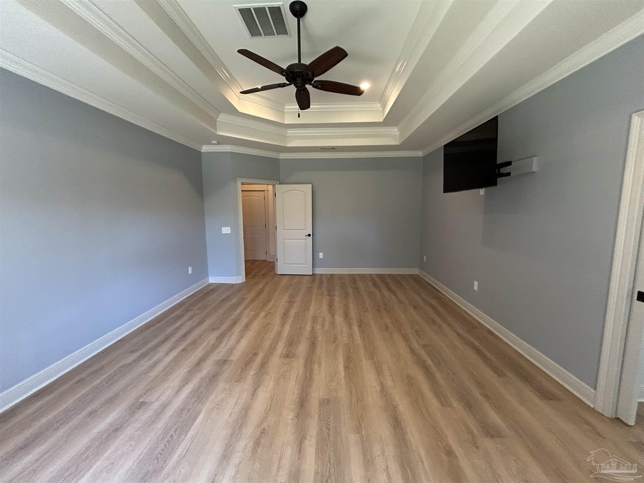 4081 Manchester Court Pace, FL 32571 - Photo 23 of 34 a view of empty room with wooden floor and ceiling fan