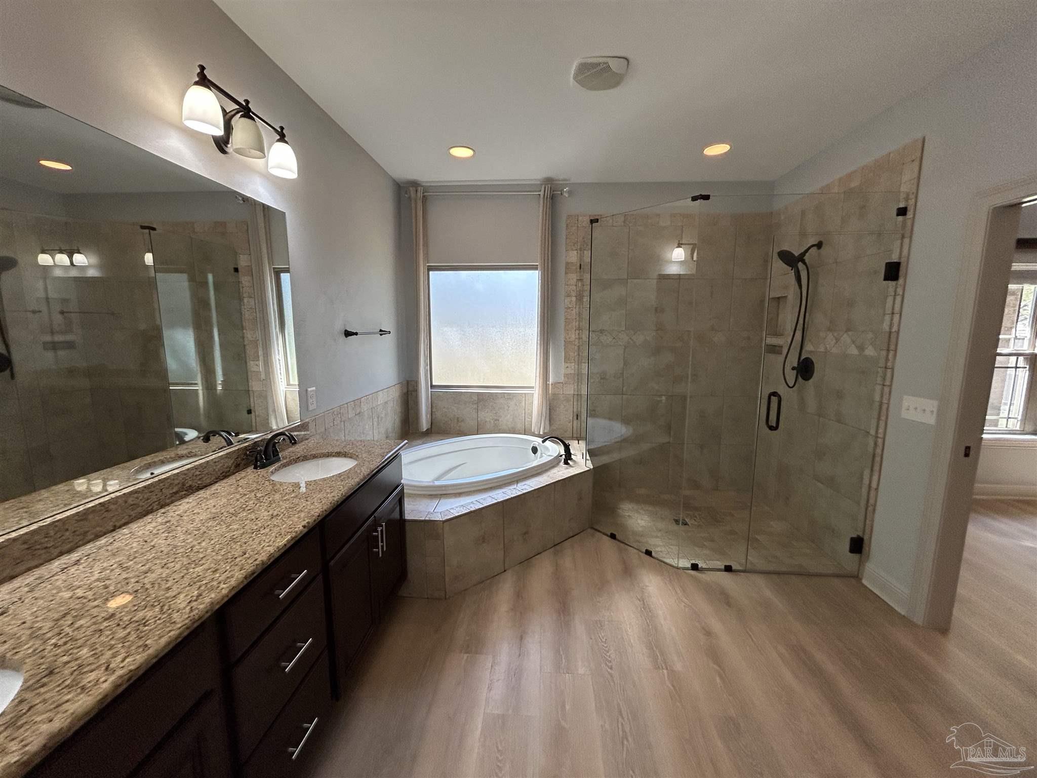 4081 Manchester Court Pace, FL 32571 - Photo 25 of 34 a bathroom with a granite countertop sink a toilet a mirror and shower