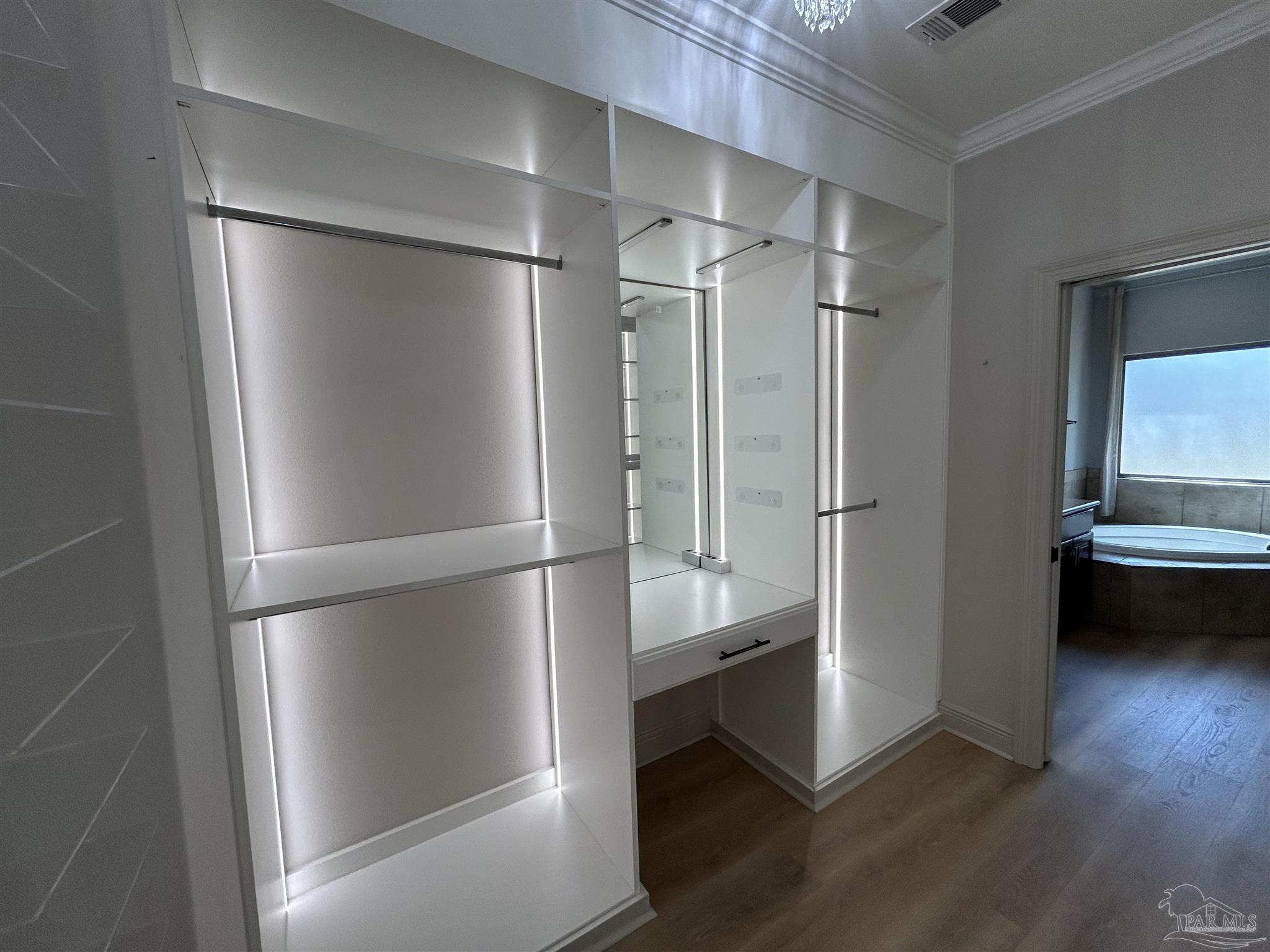 4081 Manchester Court Pace, FL 32571 - Photo 29 of 34 a view of walk in closet with empty racks