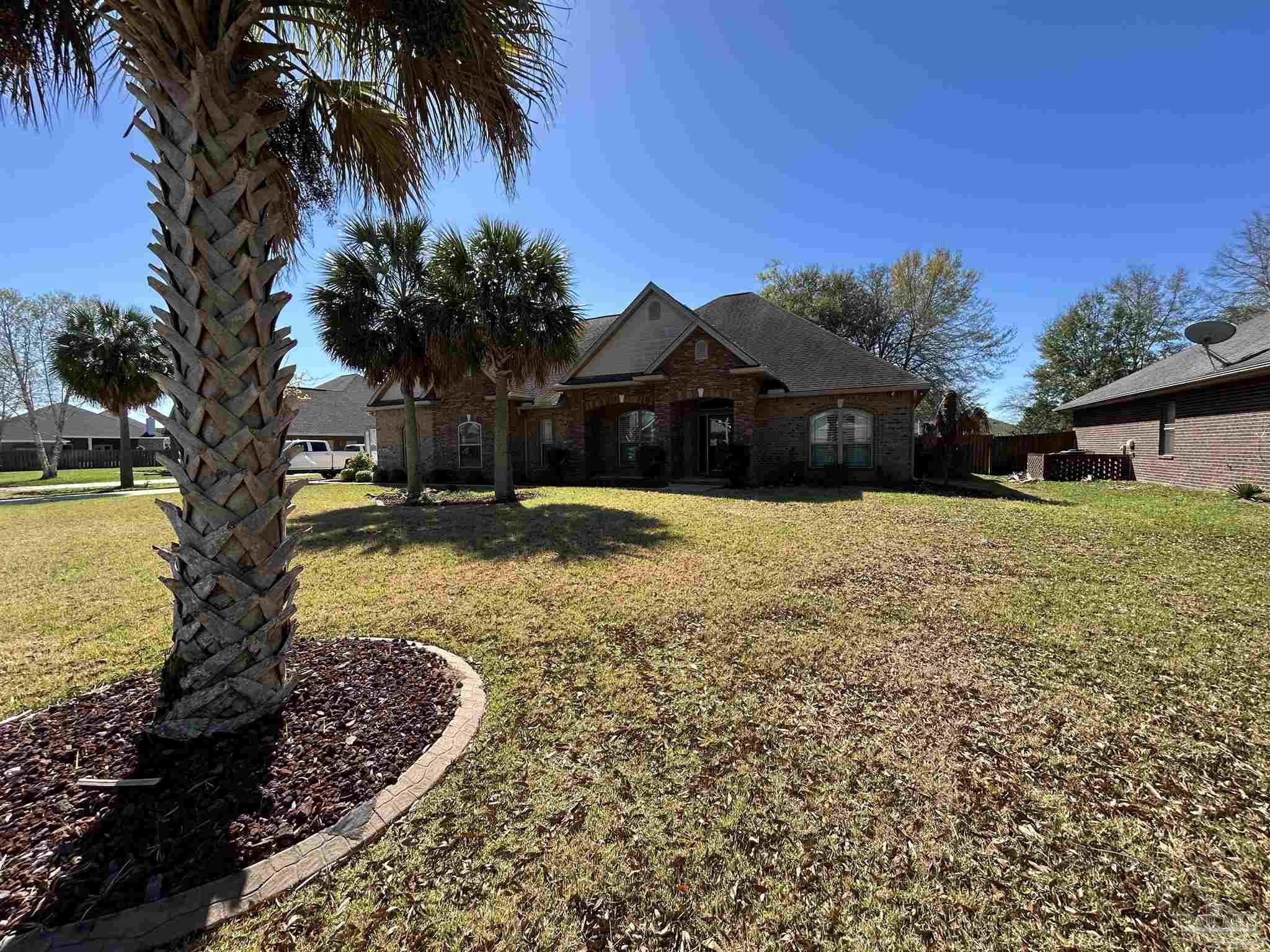 4081 Manchester Court Pace, FL 32571 - Photo 3 of 34 a swimming pool with outdoor seating and yard