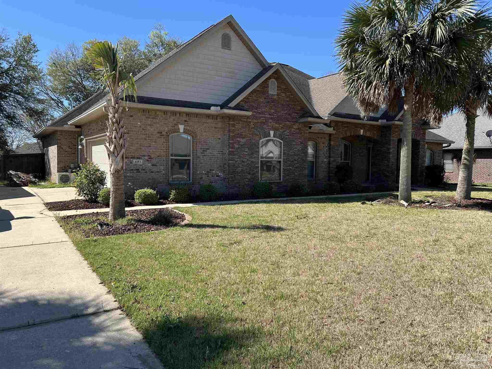 4081 Manchester Court Pace, FL 32571 - Photo 4 of 34 a front view of a house with a yard