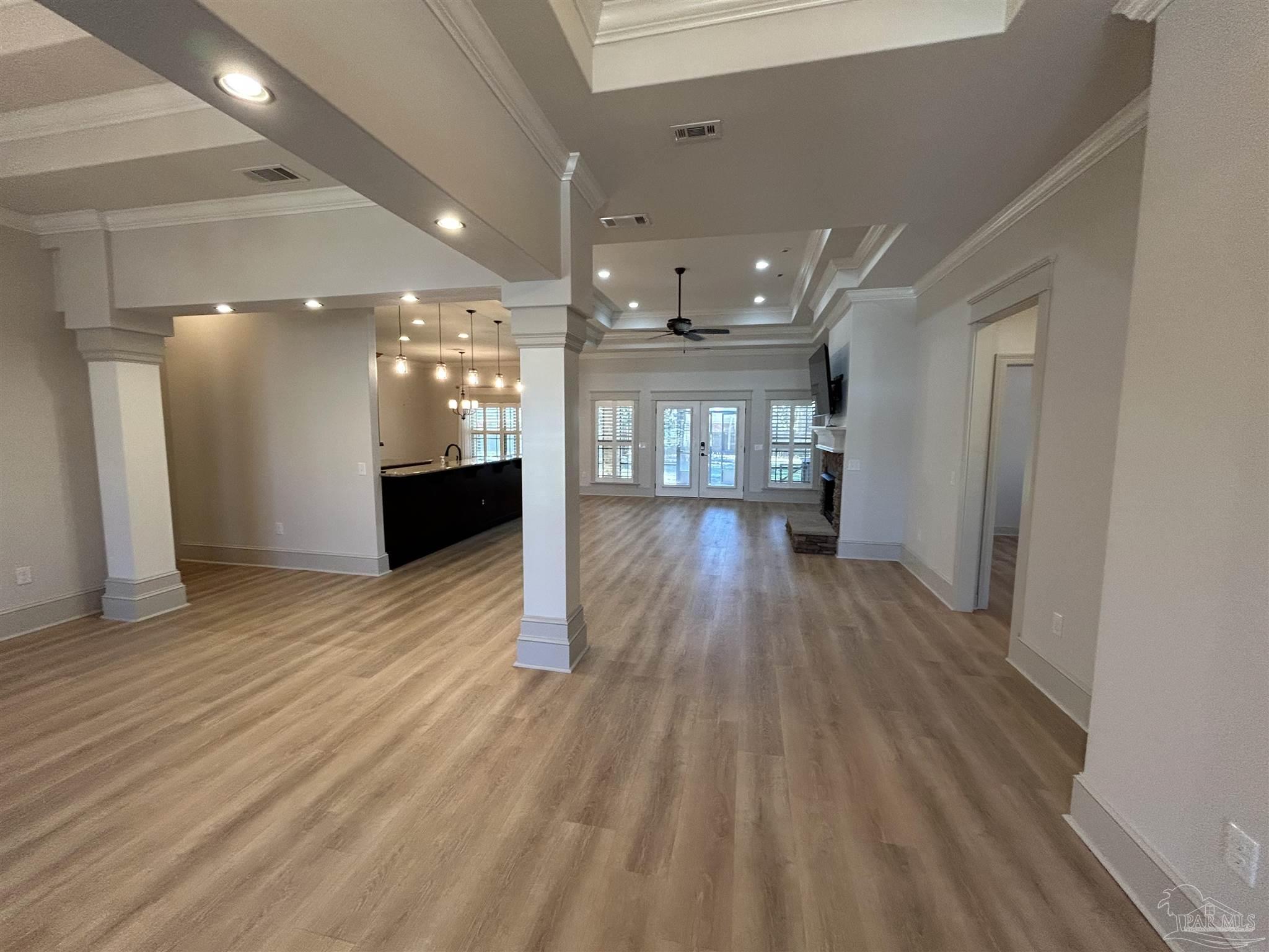 4081 Manchester Court Pace, FL 32571 - Photo 5 of 34 a view of a big room with wooden floor and windows