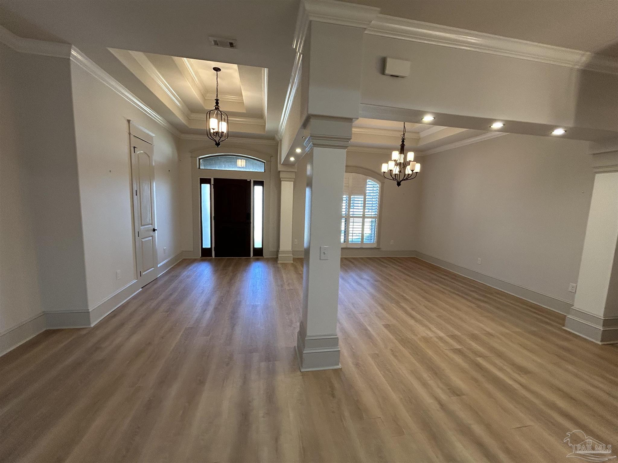 4081 Manchester Court Pace, FL 32571 - Photo 7 of 34 a view of a hallway with wooden floor and a chandelier