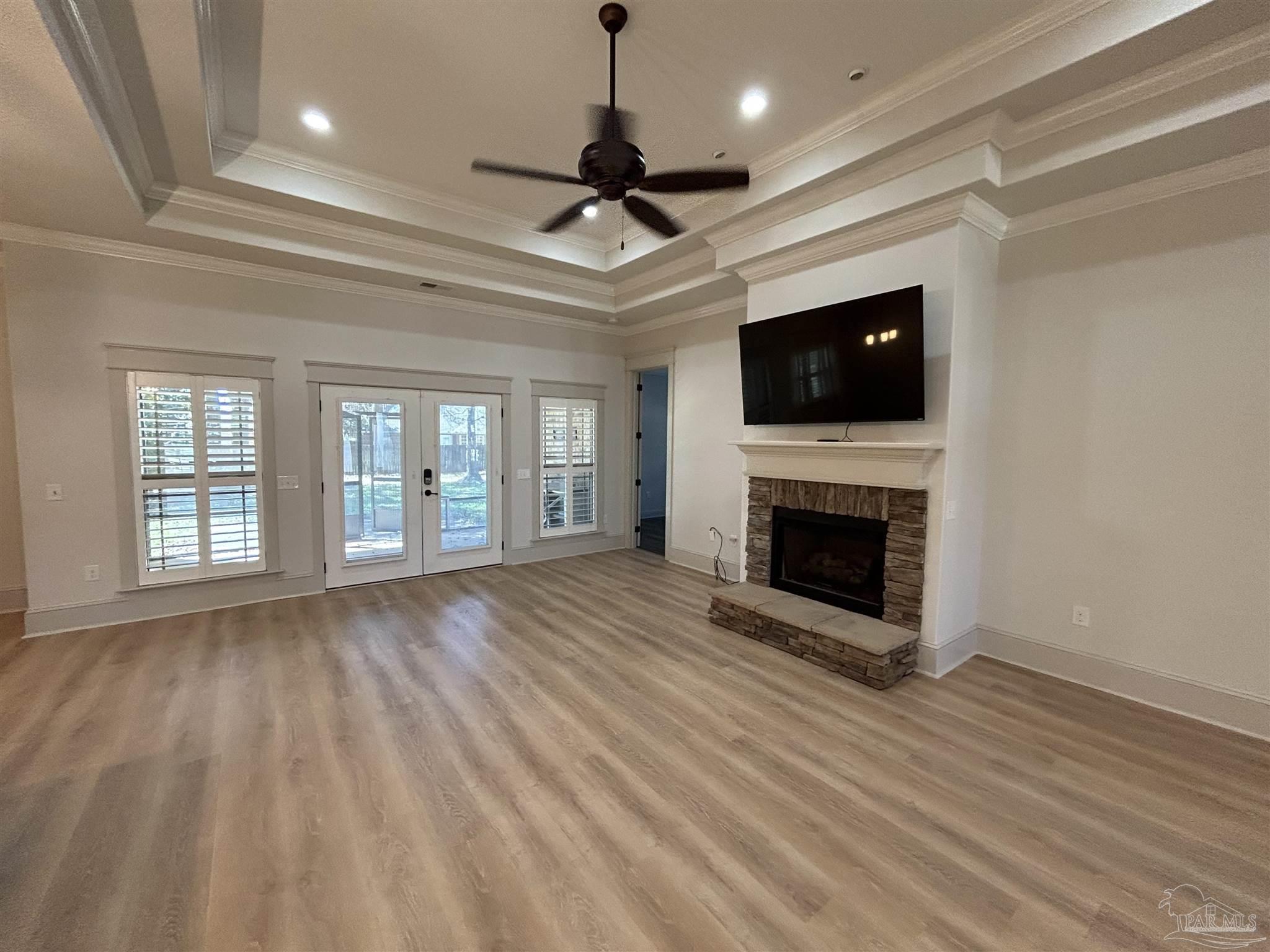4081 Manchester Court Pace, FL 32571 - Photo 8 of 34 a view of an empty room with a flat screen tv and a fireplace