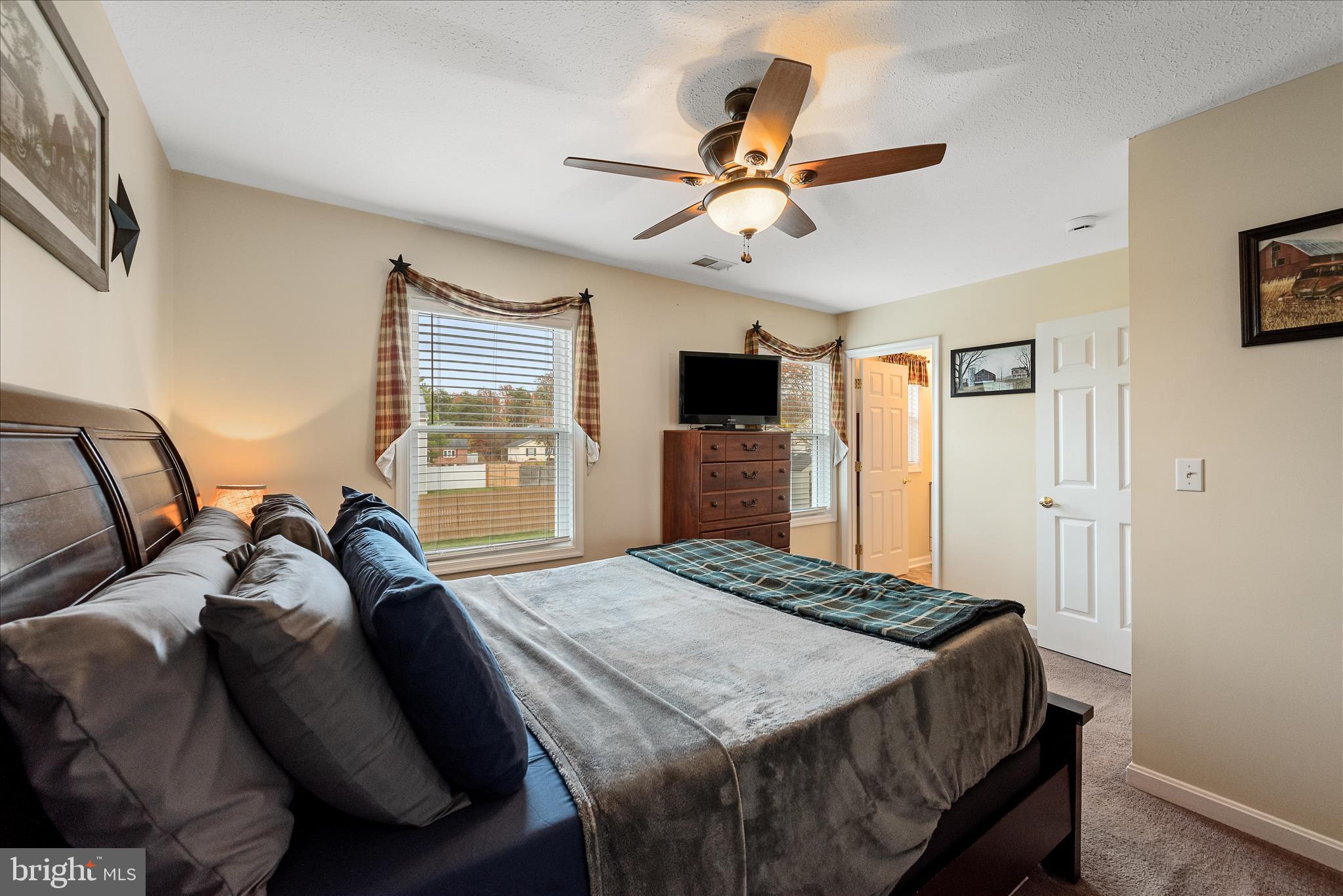 207 Killdeer Road Stephens City, VA 22655 - Photo 18 of 39 a bed room with a bed and a flat screen tv