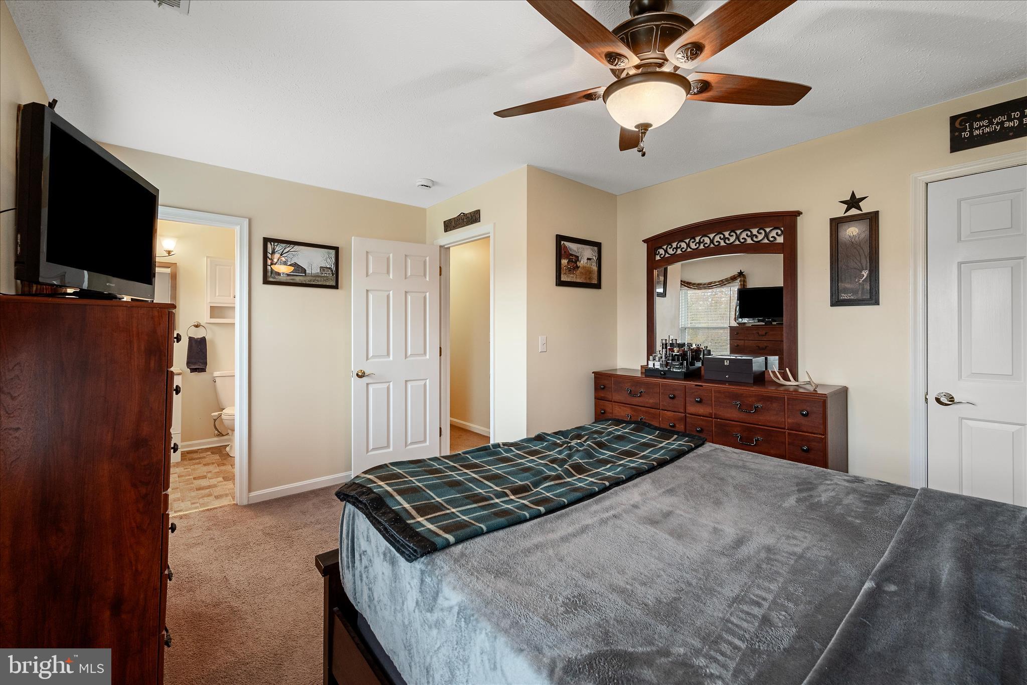 207 Killdeer Road Stephens City, VA 22655 - Photo 19 of 39 a bedroom with a bed and a flat screen tv