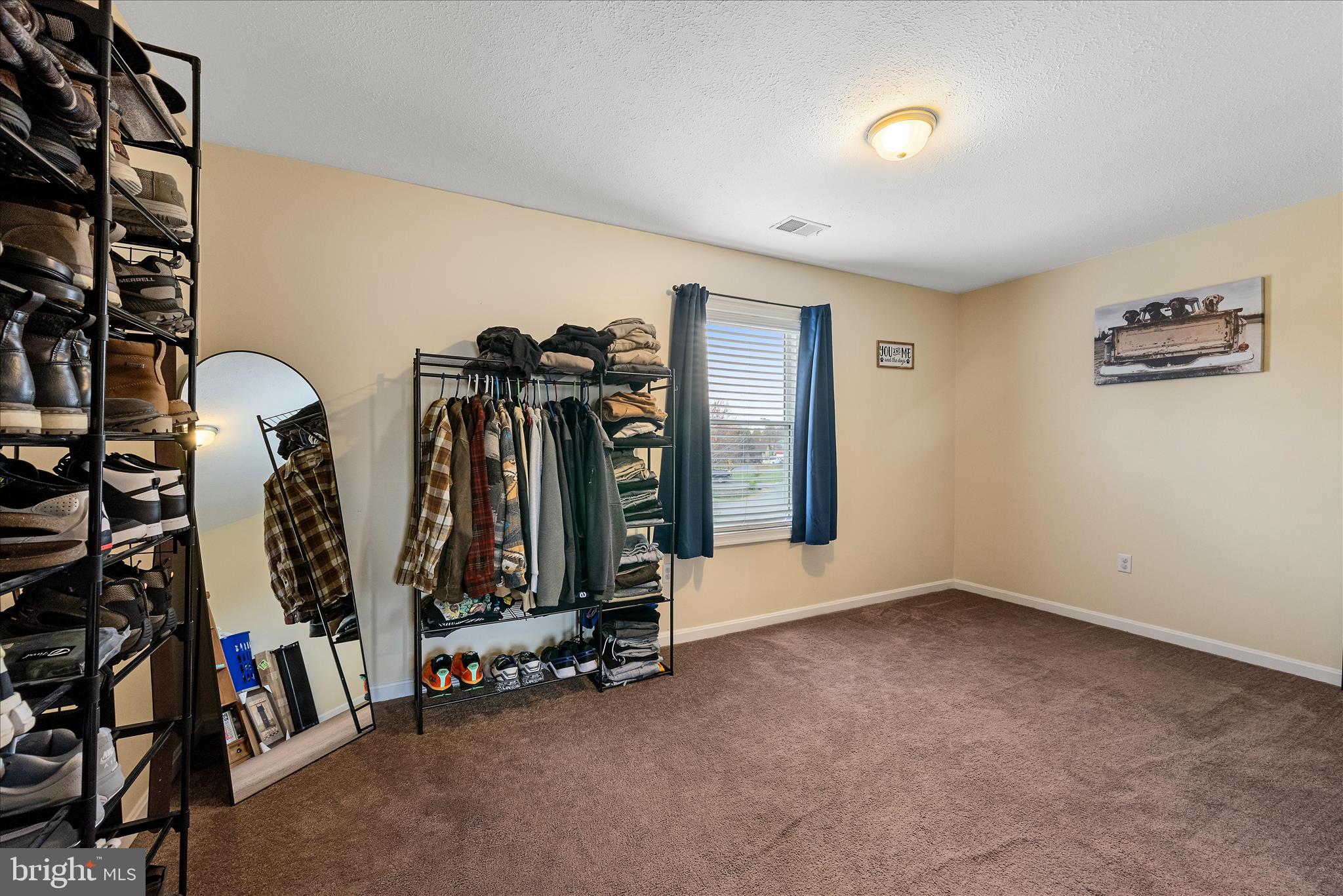 207 Killdeer Road Stephens City, VA 22655 - Photo 24 of 39 an empty room with gym equipment and a large window