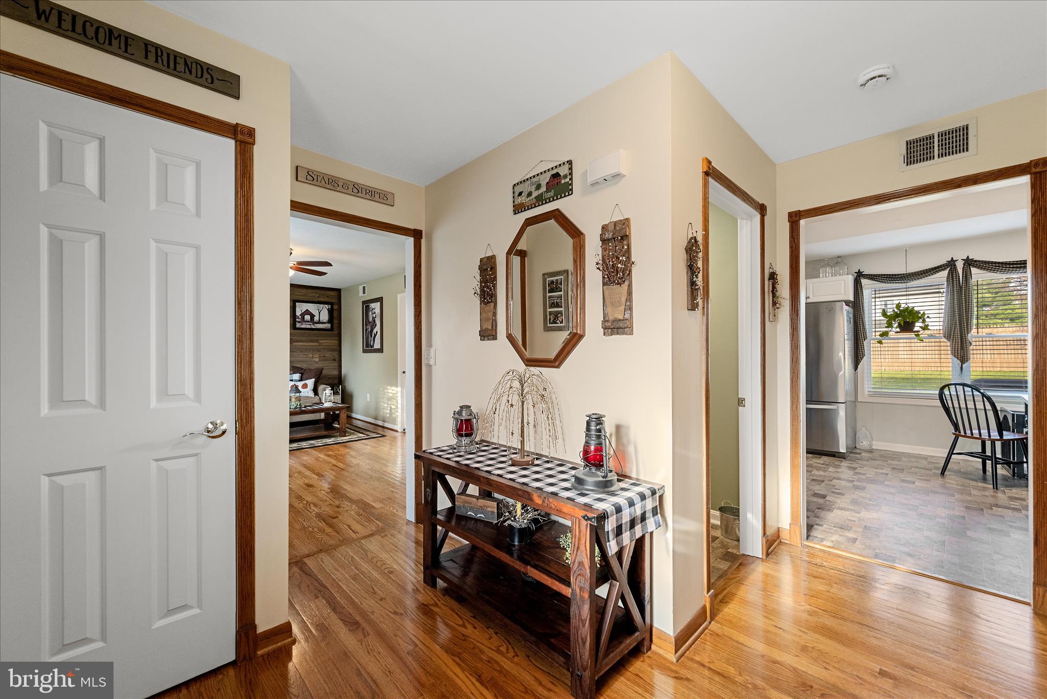 207 Killdeer Road Stephens City, VA 22655 - Photo 4 of 39 a view of a hallway with dining room and wooden floor