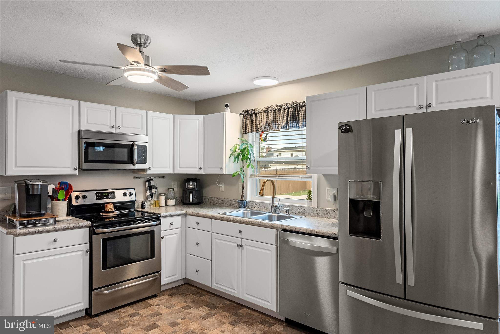207 Killdeer Road Stephens City, VA 22655 - Photo 6 of 39 a kitchen with stainless steel appliances a refrigerator sink and white cabinets