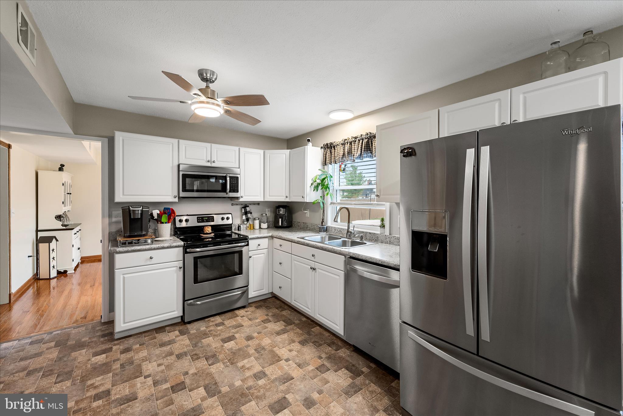 207 Killdeer Road Stephens City, VA 22655 - Photo 7 of 39 a kitchen with stainless steel appliances granite countertop a refrigerator a stove a sink and dishwasher