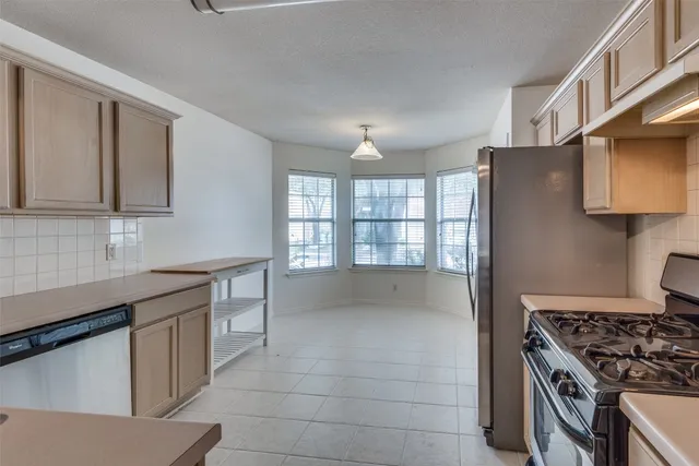 a kitchen with granite countertop a stove and a sink