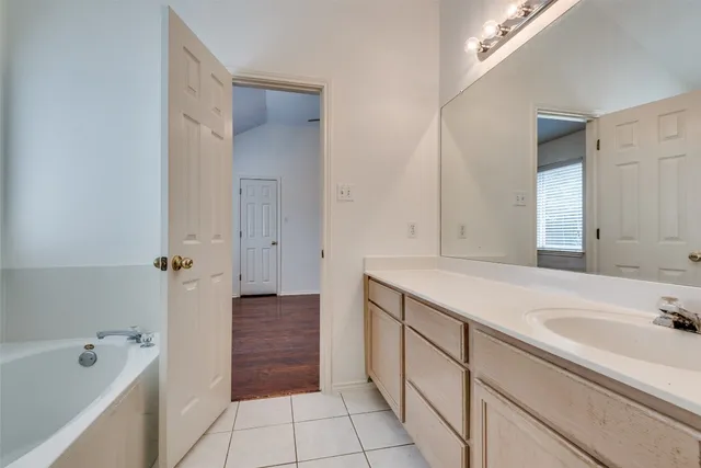 a bathroom with a bathtub and a sink