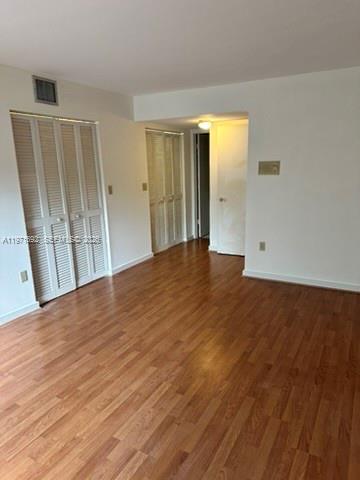 9001 Southwest 94th Street, Unit 113 Miami, FL 33176 - Photo 10 of 16 a view of an empty room with wooden floor and a window