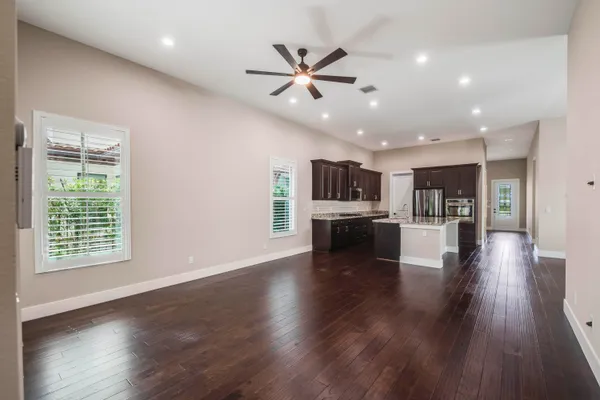 a kitchen with stainless steel appliances granite countertop a stove a sink dishwasher and cabinets with wooden floor