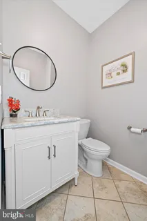 a bathroom with a toilet a sink and a mirror
