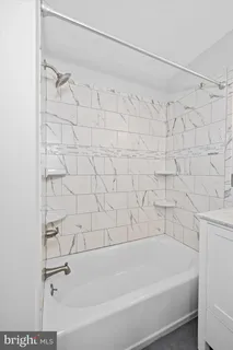 a bathroom with a bathtub and a shower