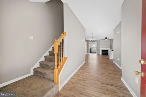 a view of a hallway view with wooden floor and staircase