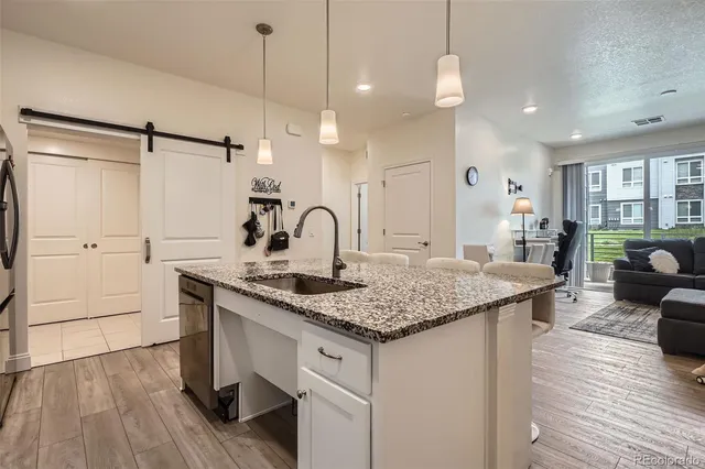 a kitchen with center island and wooden floor