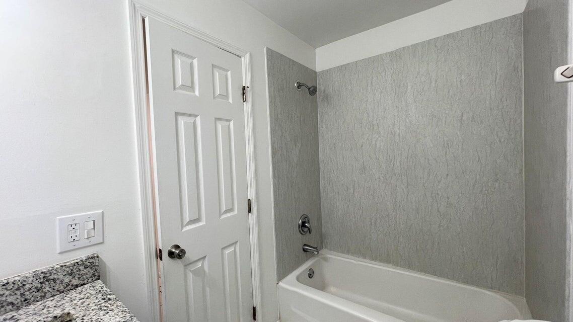 4606 Southeast Binnacle Way, Unit 3 Stuart, FL 34997 - Photo 5 of 5 a bathroom with a bathtub