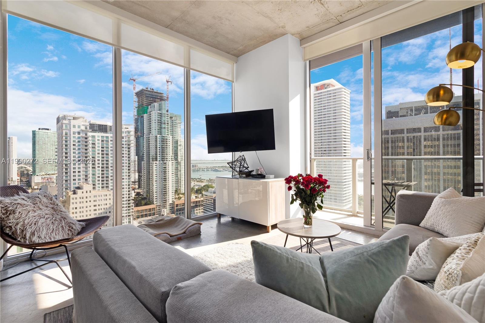 151 Southeast 1st Street, Unit 2802 Miami, FL 33131 - Photo 1 of 31 a living room with furniture and a large window
