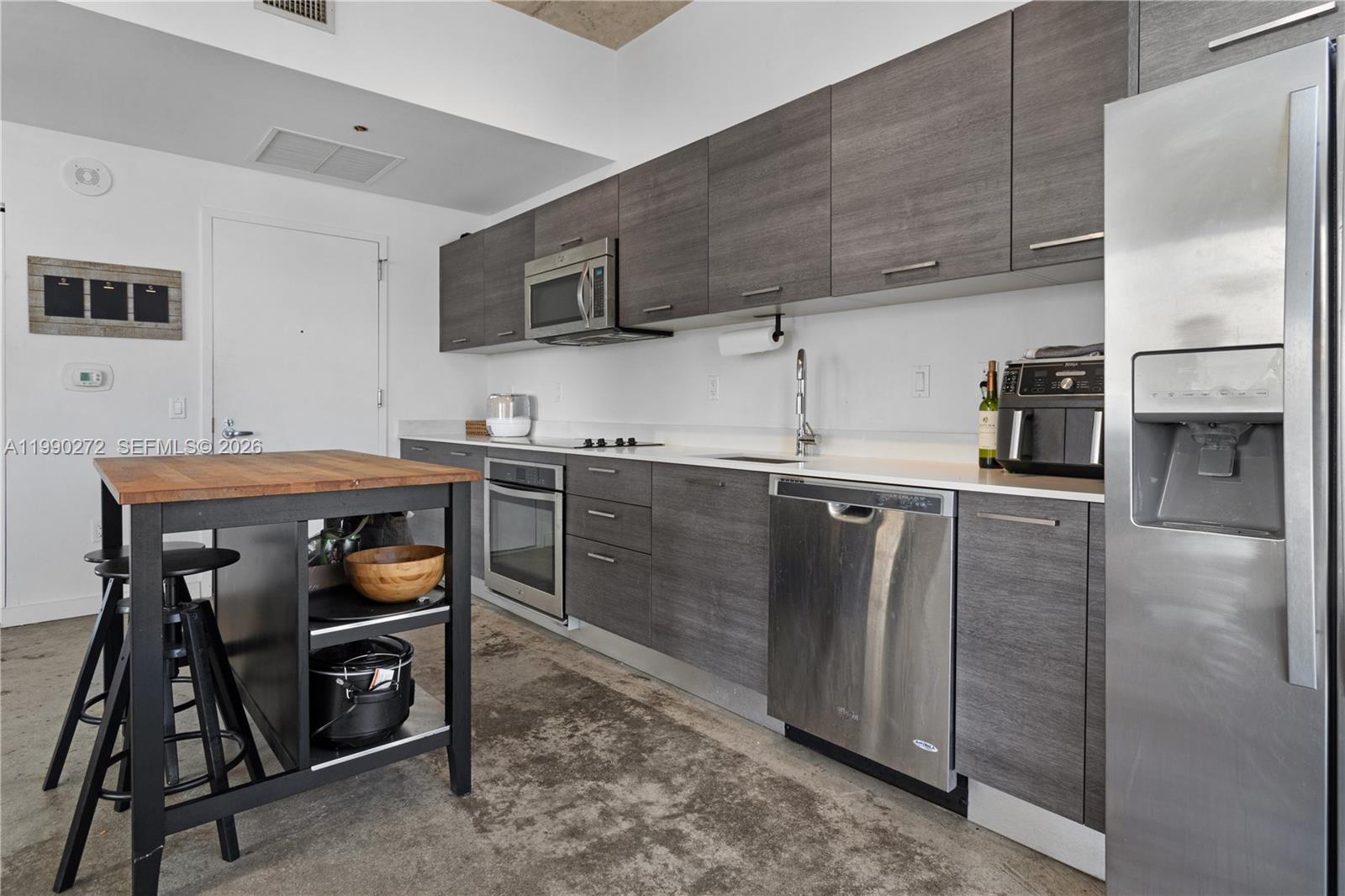 151 Southeast 1st Street, Unit 2802 Miami, FL 33131 - Photo 14 of 31 a kitchen with stainless steel appliances granite countertop a refrigerator and a stove