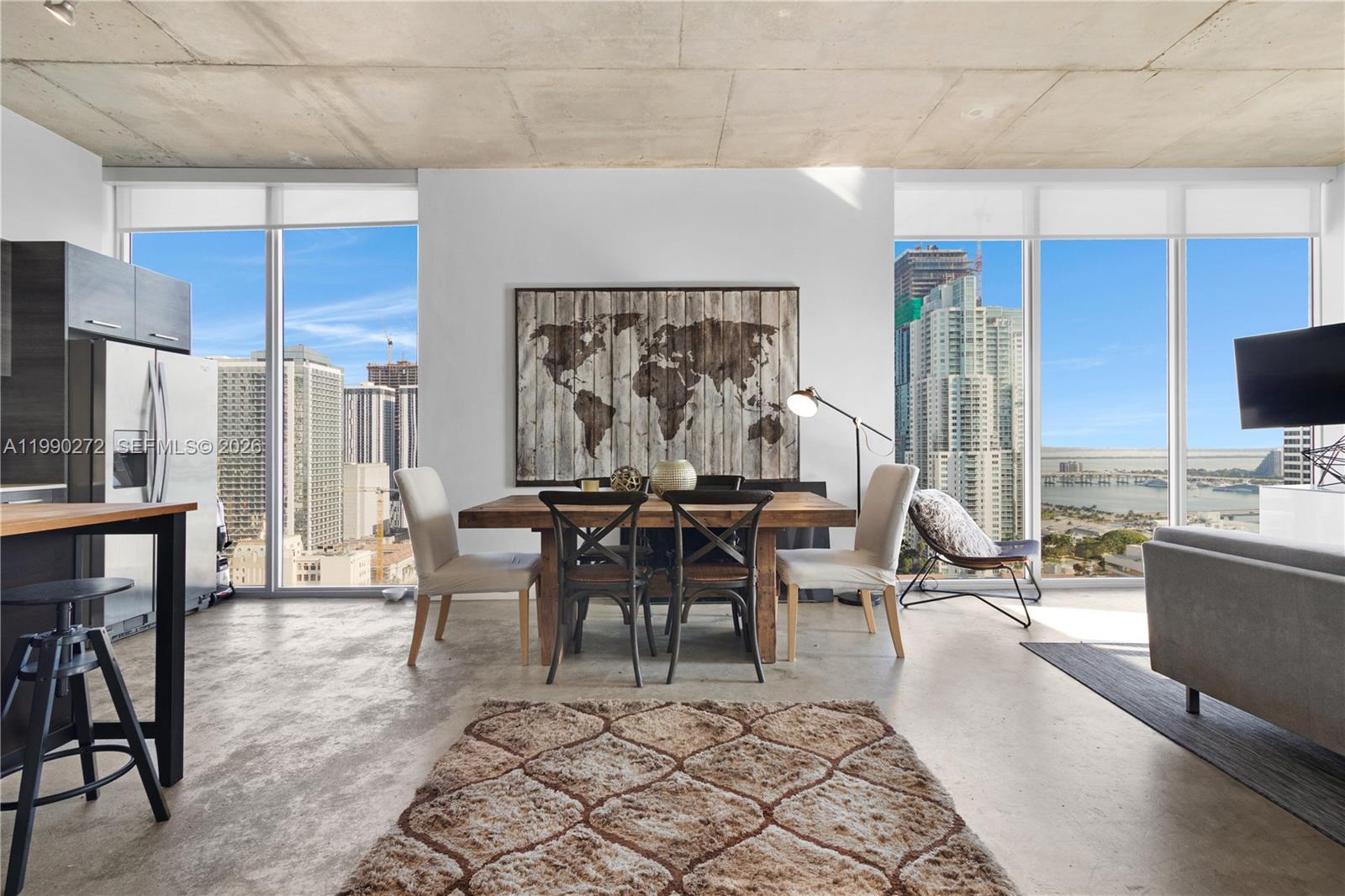 151 Southeast 1st Street, Unit 2802 Miami, FL 33131 - Photo 2 of 31 a living room with furniture a rug and a painting on the wall