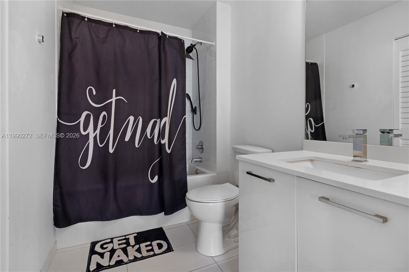 151 Southeast 1st Street, Unit 2802 Miami, FL 33131 - Photo 21 of 31 a bathroom with a sink and toilet