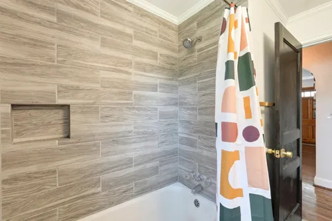 a bathroom with a bathtub and shower