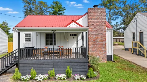 a view of a brick house with wooden fence