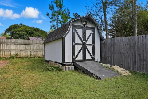 a view of backyard with a barn and a cactus plant