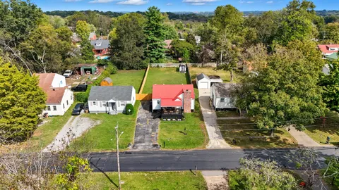 an aerial view of a house with a yard swimming pool and outdoor seating