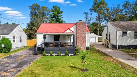 a view of a house with backyard sitting area and garden