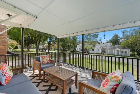 a balcony with furniture and a potted plant