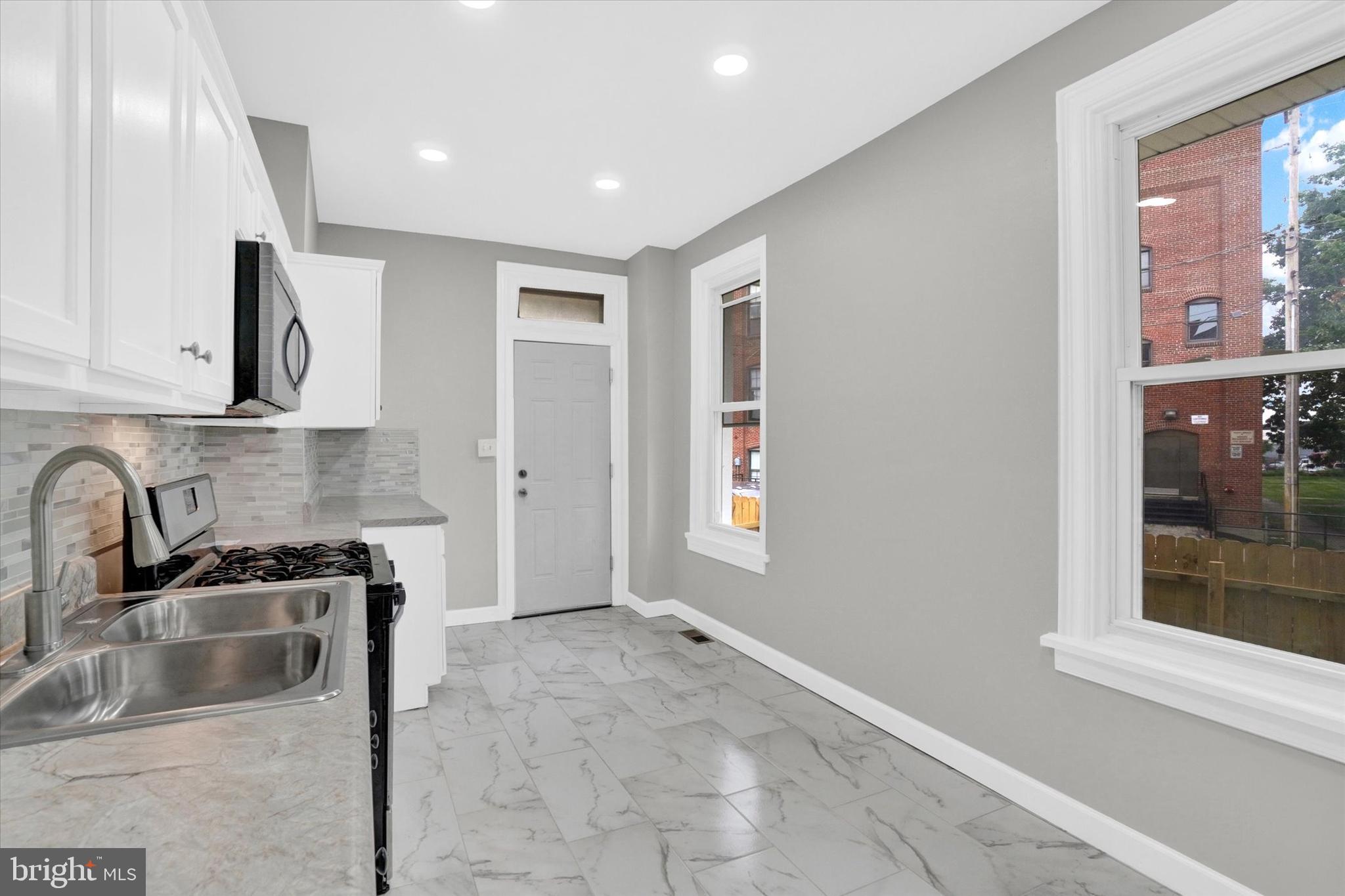 359 East Prospect Street York, PA 17403 - Photo 7 of 27 a kitchen with stainless steel appliances granite countertop a sink and a stove top oven
