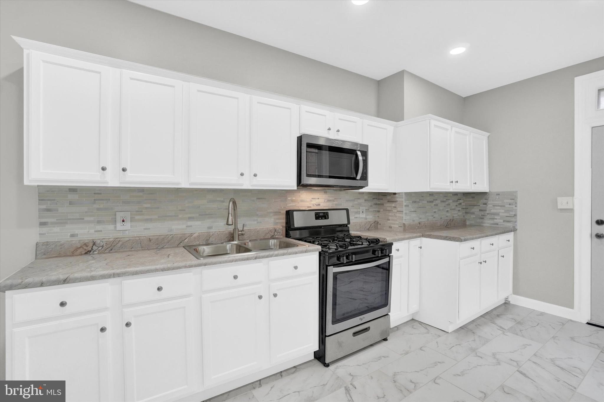 359 East Prospect Street York, PA 17403 - Photo 8 of 27 a kitchen with granite countertop white cabinets and stainless steel appliances