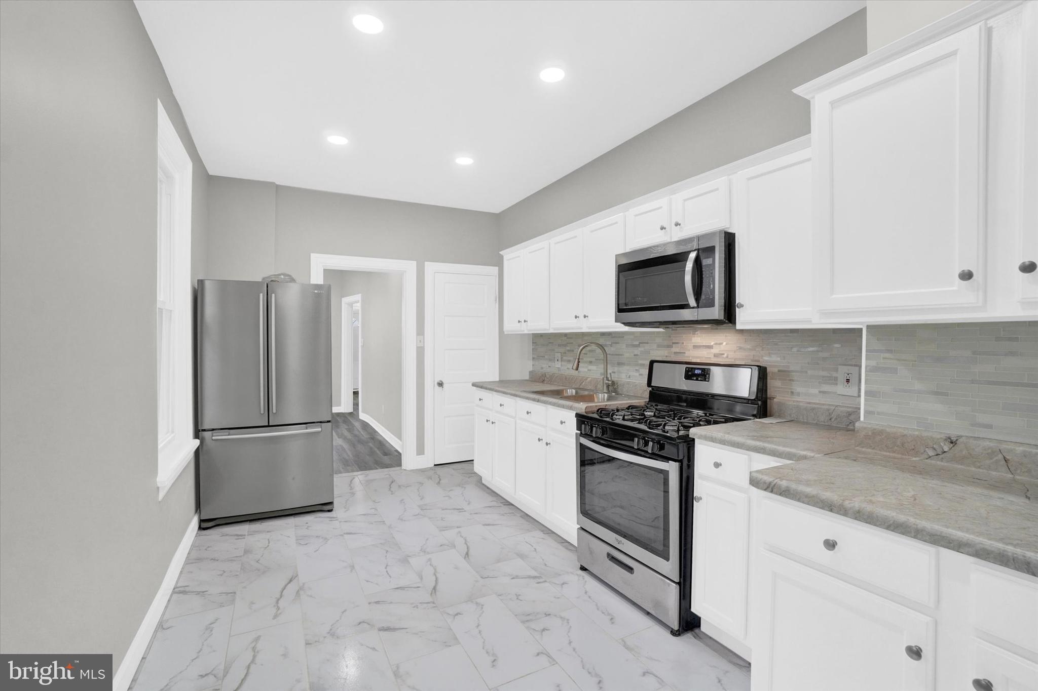 359 East Prospect Street York, PA 17403 - Photo 9 of 27 a kitchen with granite countertop a refrigerator and a stove top oven