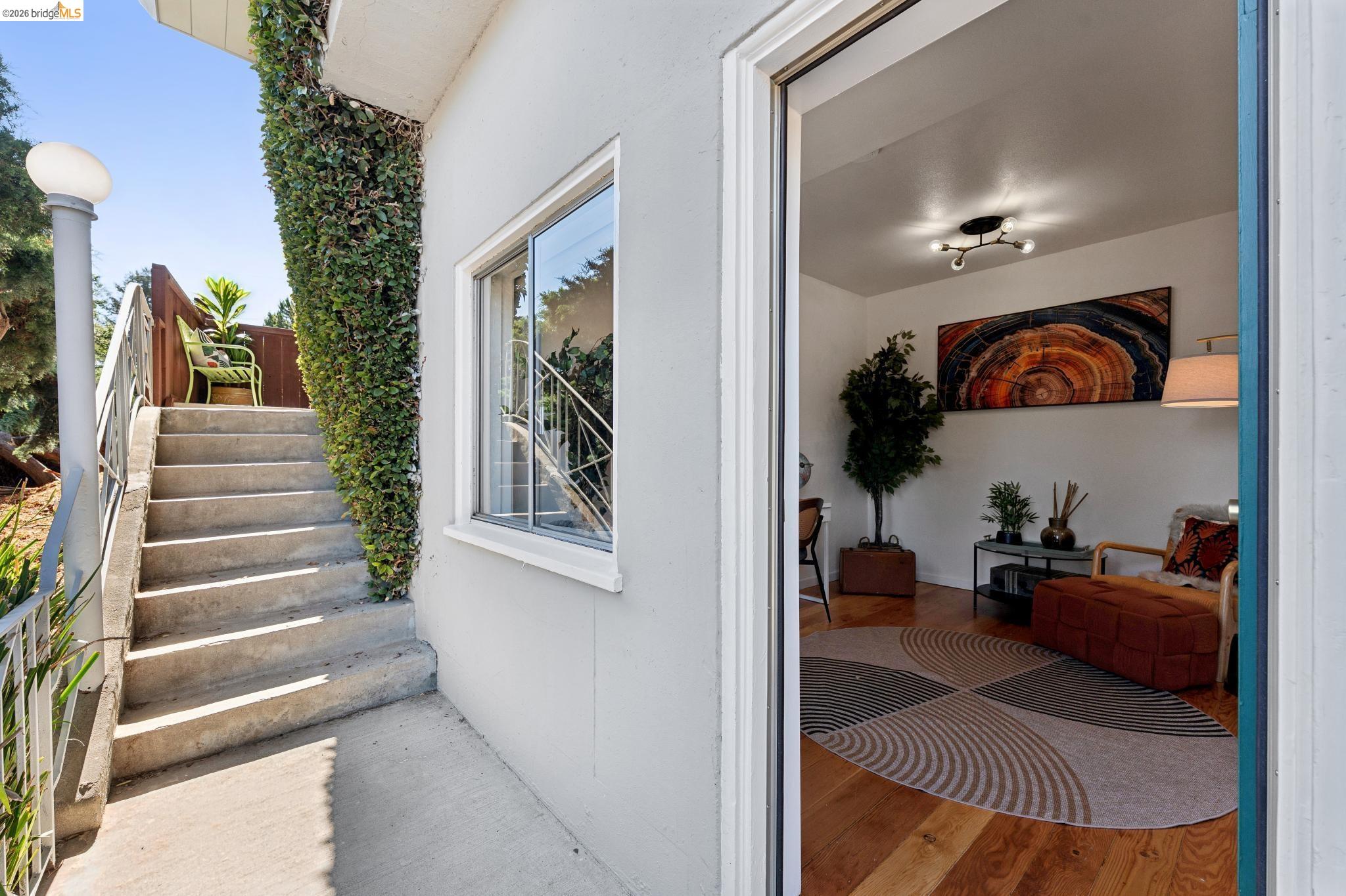 2301 Oak Street Berkeley, CA 94708 - Photo 49 of 61 Exterior concrete staircase with metal railings and a wall of established climbing greenery, leading to an upper landing