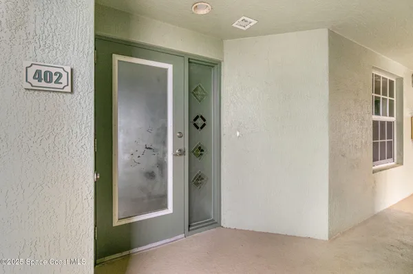 a view of a hallway with windows and bathroom