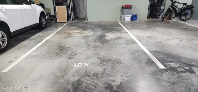 a view of a garage with rack and bicycle