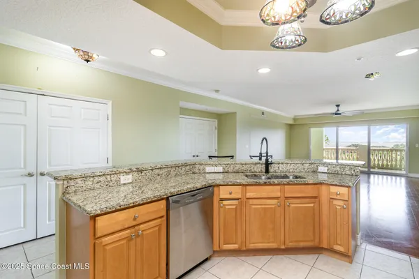 a kitchen with cabinets and chandelier