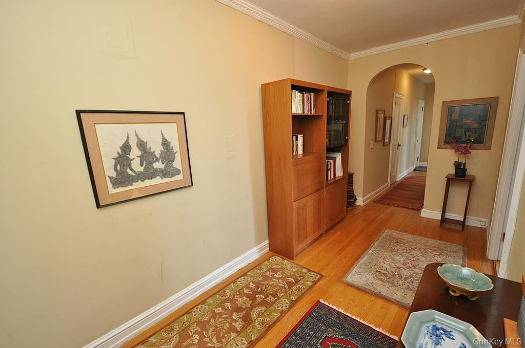 143 Garth Road, Unit 5J Scarsdale, NY 10583 - Photo 23 of 47 a view of a hallway with furniture and wooden floor