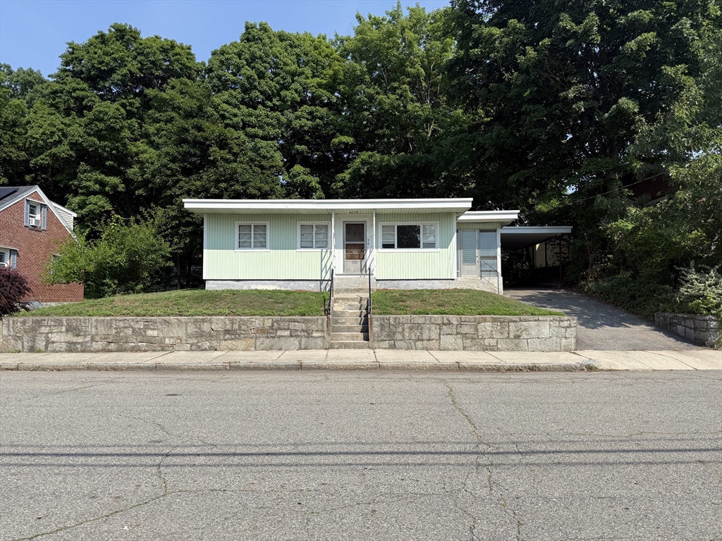36 5th Avenue Lowell, MA 01854 - Photo 16 of 16 a front view of a house with a garden and yard