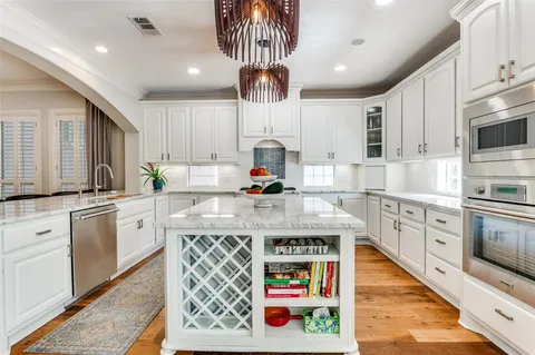 a kitchen with stainless steel appliances granite countertop a stove and cabinets